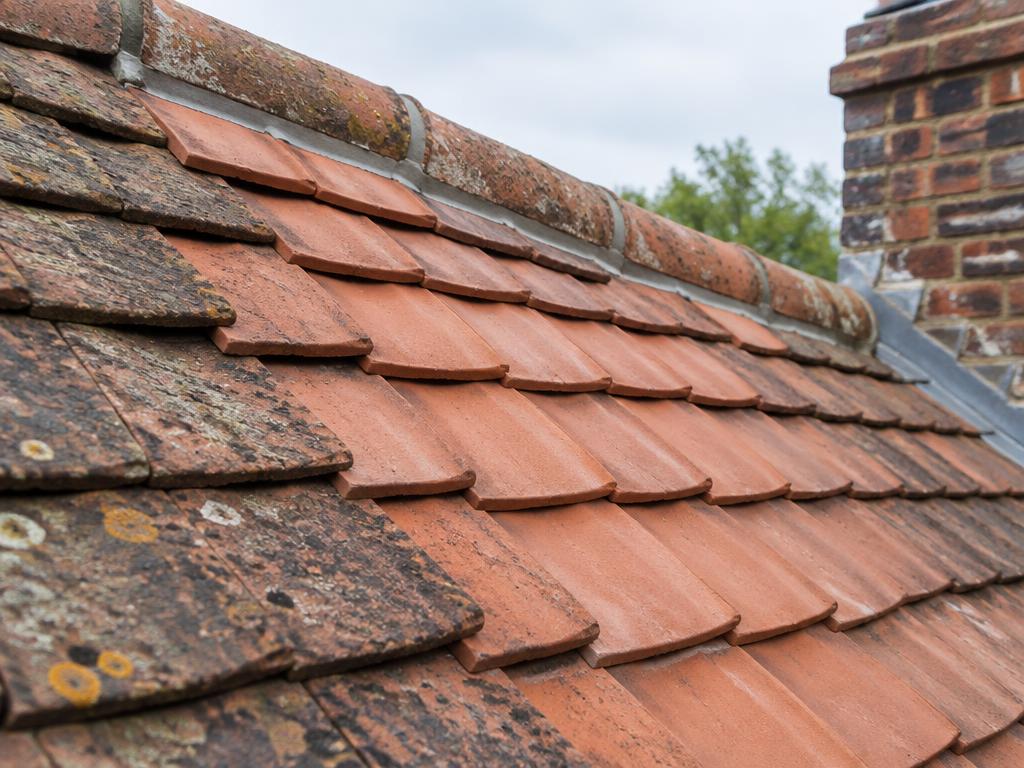 Clay tiled roof with a repaired section